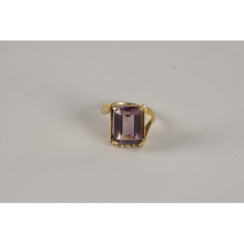 313 - A LADIES' LARGE 18CT GOLD AMETHYST AND DIAMOND RING the large emerald cut amethyst in a four claw se... 