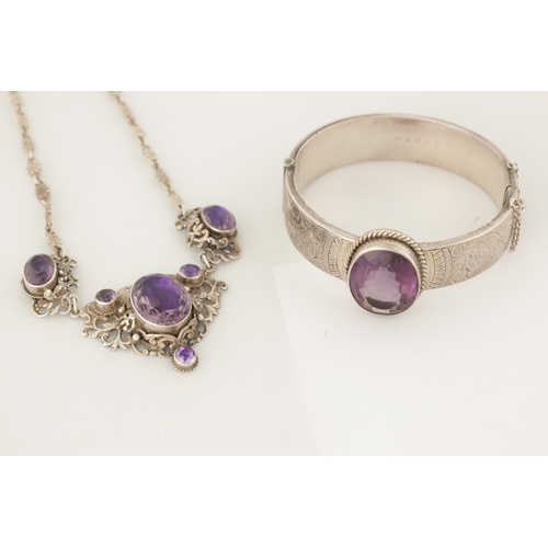 316 - A VINTAGE SILVER AND AMETHYST BANGLE AND PENDANT NECKLACE The bangle with scrollwork decoration and ... 