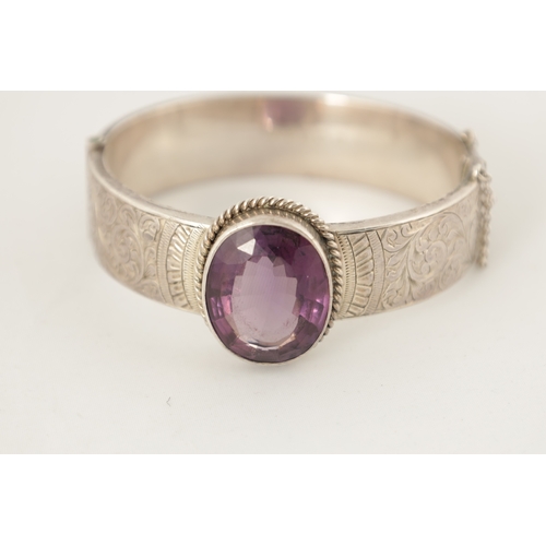 316 - A VINTAGE SILVER AND AMETHYST BANGLE AND PENDANT NECKLACE The bangle with scrollwork decoration and ... 