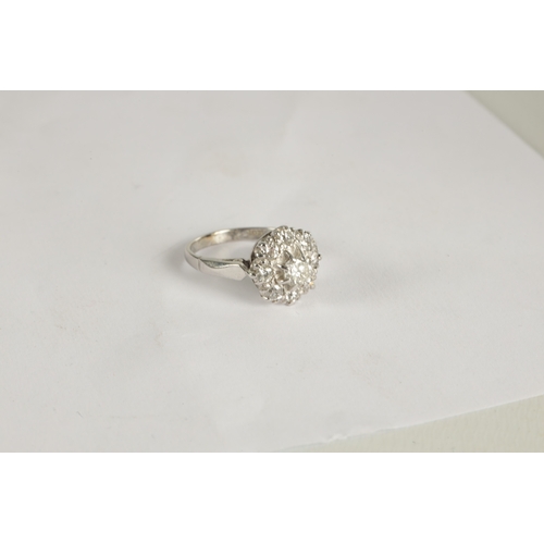 324 - A LADIES' 18CT WHITE GOLD DIAMOND DAISY RING the brilliant cut centre stone app. 0.42ct surrounded b... 