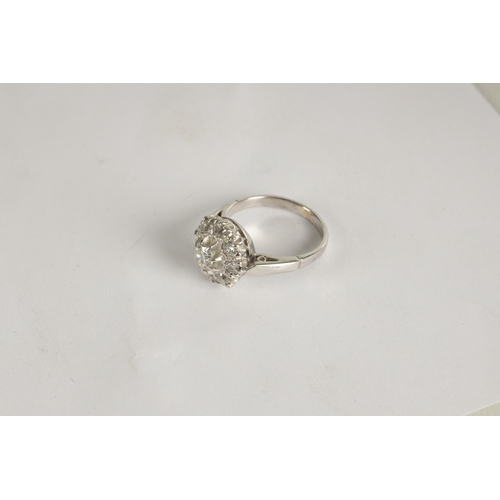 324 - A LADIES' 18CT WHITE GOLD DIAMOND DAISY RING the brilliant cut centre stone app. 0.42ct surrounded b... 