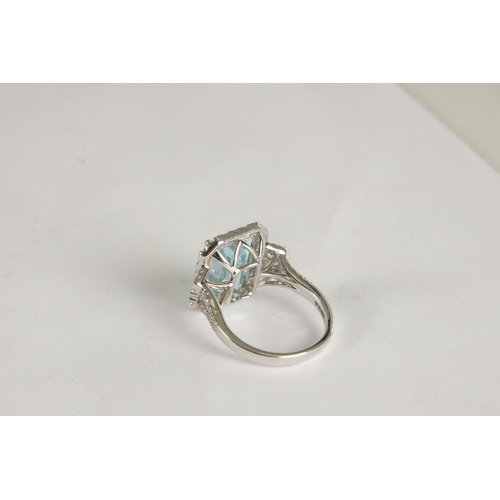 325 - A LADIES' 18CT WHITE GOLD AQUAMARINE AND DIAMOND RING the large emerald cut aquamarine app. 6ct surr... 