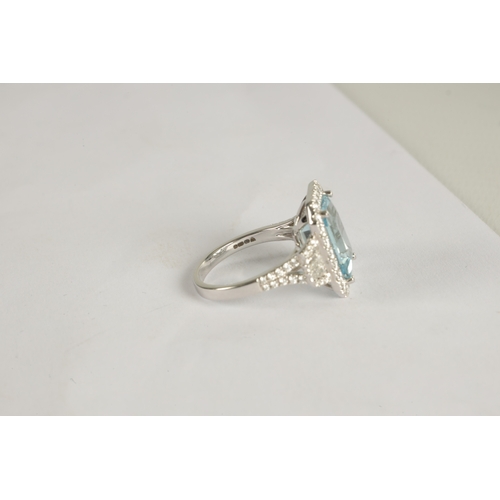 325 - A LADIES' 18CT WHITE GOLD AQUAMARINE AND DIAMOND RING the large emerald cut aquamarine app. 6ct surr... 