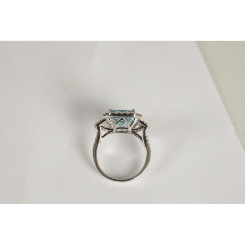 325 - A LADIES' 18CT WHITE GOLD AQUAMARINE AND DIAMOND RING the large emerald cut aquamarine app. 6ct surr... 