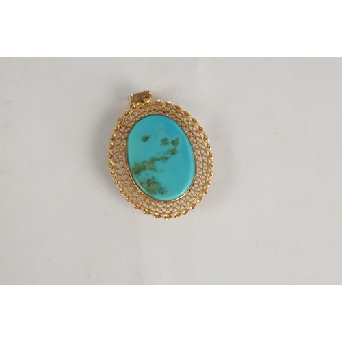 332 - A LADIES' 18CT GOLD CABOCHON TURQUOISE OVAL PENDANT the large stone set in a filigree frame with loo... 