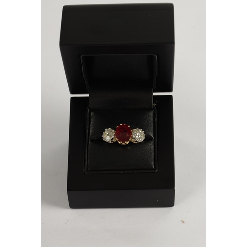 339 - A FINE 18CT YELLOW GOLD RUBY AND TWO-STONE DIAMOND RING straight set with oval centre facet-cut ruby... 