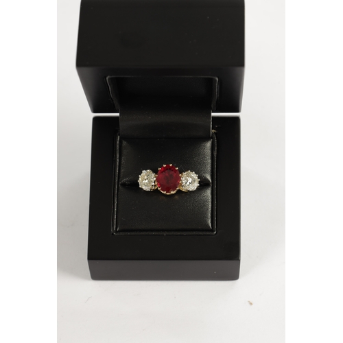 339 - A FINE 18CT YELLOW GOLD RUBY AND TWO-STONE DIAMOND RING straight set with oval centre facet-cut ruby... 