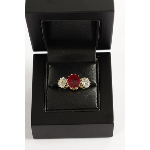 339 - A FINE 18CT YELLOW GOLD RUBY AND TWO-STONE DIAMOND RING straight set with oval centre facet-cut ruby... 