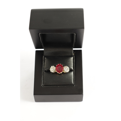 339 - A FINE 18CT YELLOW GOLD RUBY AND TWO-STONE DIAMOND RING straight set with oval centre facet-cut ruby... 