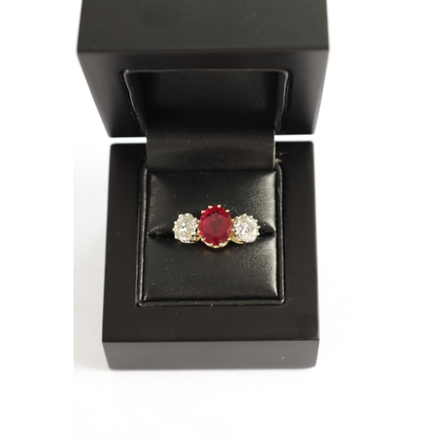 339 - A FINE 18CT YELLOW GOLD RUBY AND TWO-STONE DIAMOND RING straight set with oval centre facet-cut ruby... 