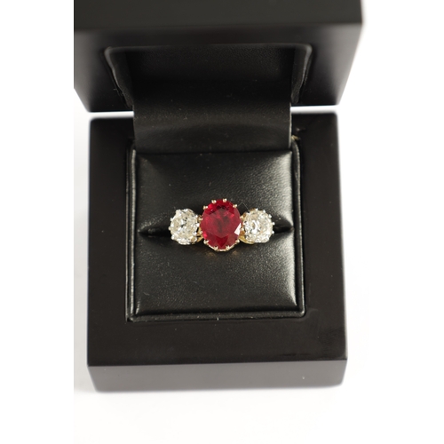 339 - A FINE 18CT YELLOW GOLD RUBY AND TWO-STONE DIAMOND RING straight set with oval centre facet-cut ruby... 