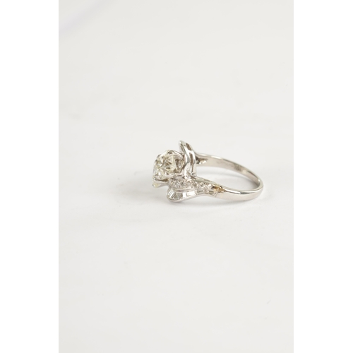 346 - A FINE PLATINUM SET CROSS-OVER TWO-STONE DIAMOND RING with twisted shoulders, each channel set with ... 