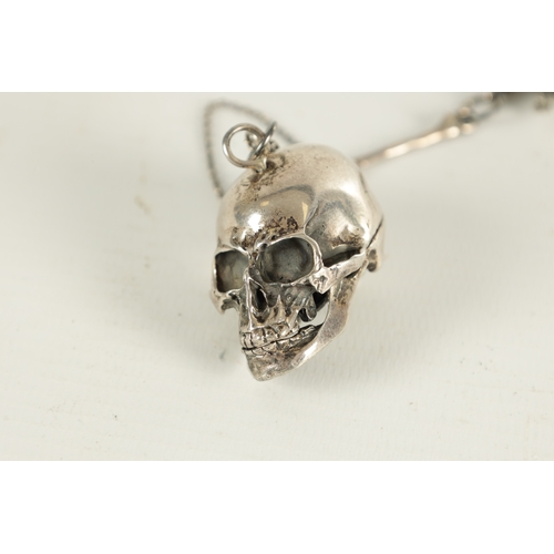 374 - A 19TH CENTURY SILVER SKULL FOB POCKET WATCH CHAIN with bones and a hinged skull vesta. (33cm long)