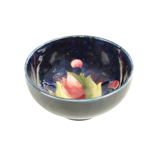 39 - A WILLIAM MOORCROFT SMALL-FOOTED BOWL CIRCA 1930'S/40'S the centre incised and decorated in the leaf... 