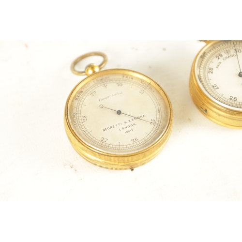 394 - TWO GILT BRASS CASED POCKET BAROMETERS, one in the originally Moroccan leather case, the other signe... 