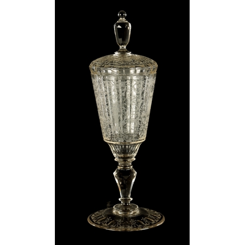 4 - A 20TH CENTURY BOHEMIAN CRYSTAL GLASS-LIDDED GOBLET of faceted form with etched scrollwork decoratio... 