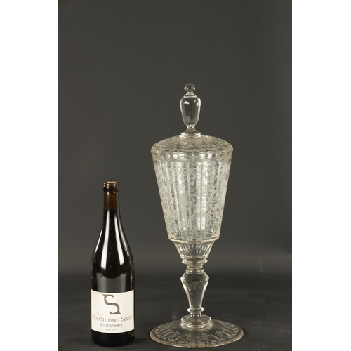 4 - A 20TH CENTURY BOHEMIAN CRYSTAL GLASS-LIDDED GOBLET of faceted form with etched scrollwork decoratio... 