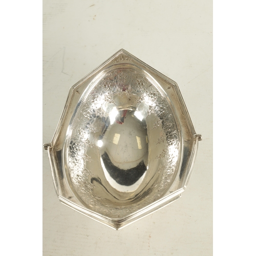 404 - A GEORGE III SILVER SWEETMEAT BASKET the ovoid octagonal shaped dish with bright cut decoration and ... 