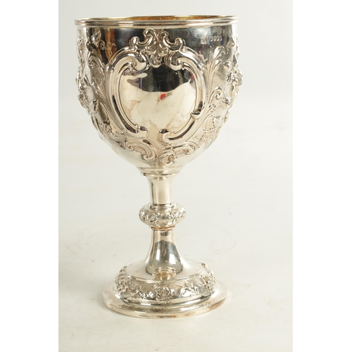 405 - A VICTORIAN GIANT SIZE SILVER GOBLET of impressive design with deeply embossed flowerhead and leafwo... 