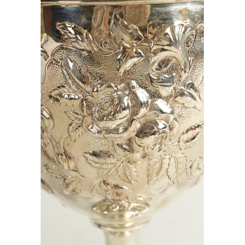 405 - A VICTORIAN GIANT SIZE SILVER GOBLET of impressive design with deeply embossed flowerhead and leafwo... 