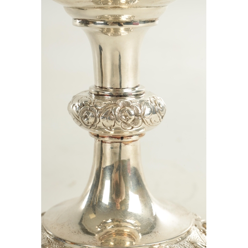 405 - A VICTORIAN GIANT SIZE SILVER GOBLET of impressive design with deeply embossed flowerhead and leafwo... 