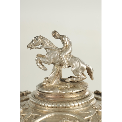 410 - A LARGE ELKINGTON & CO STYLE SILVER PLATE CIRCULAR CASKET DEPICTING HORSES AND HORSEMEN with pull-of... 