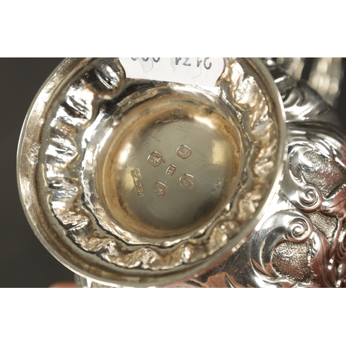 413 - AN IRISH FLORAL EMBOSSED SILVER CHRISTENING MUG, with scroll handle and raised on circular foot. - 1... 