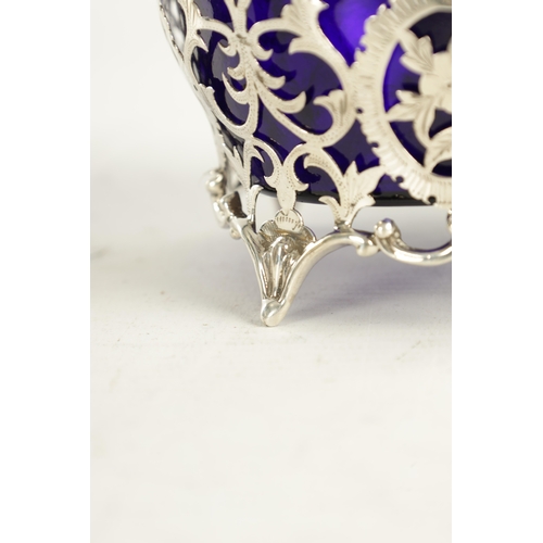 415 - A VICTORIAN SILVER BASKET WITH BLUE GLASS LINER with scrolled open leafwork body, hatched, flowerhea... 