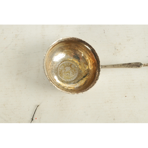 416 - A GEORGIAN SILVER PUNCH LADLE with coin inset to the base dated 1766 and twisted whalebone handle. T... 