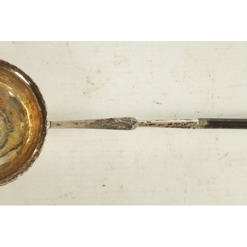 416 - A GEORGIAN SILVER PUNCH LADLE with coin inset to the base dated 1766 and twisted whalebone handle. T... 