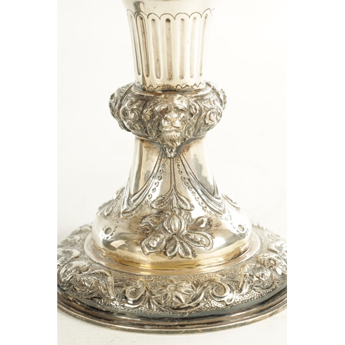 418 - A GEORGE III GIANT-SIZE SILVER GOBLET the body deeply embossed with winged cherub heads, leafing fru... 