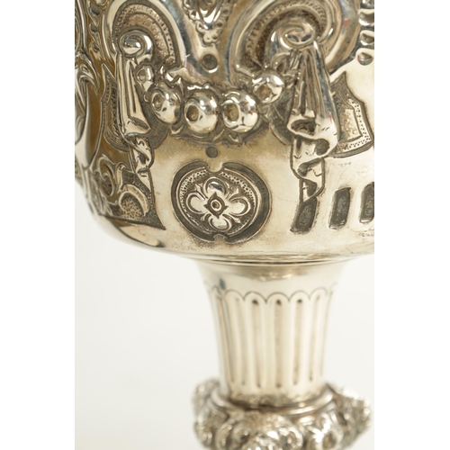 418 - A GEORGE III GIANT-SIZE SILVER GOBLET the body deeply embossed with winged cherub heads, leafing fru... 