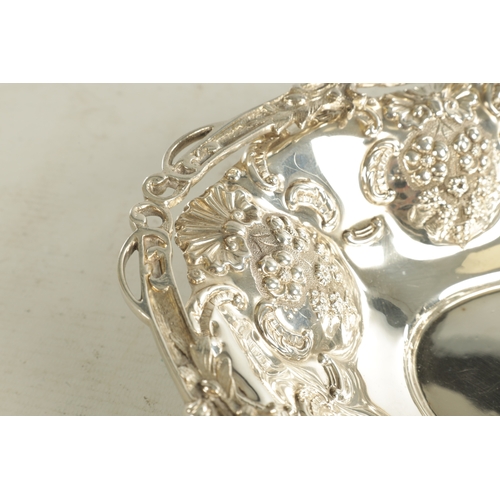 425 - EDWARD VII OVAL SILVER FRUIT BASKET with ornate cast folding handle and pierced fruiting vine work b... 