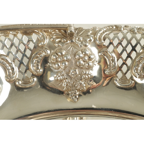 425 - EDWARD VII OVAL SILVER FRUIT BASKET with ornate cast folding handle and pierced fruiting vine work b... 