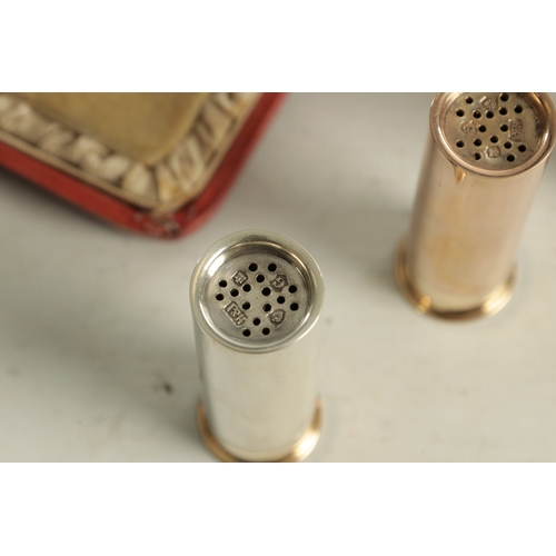 426 - AN EARLY 20TH CENTURY THREE SILVER 'SHOTGUN' CARTRIDGE PEPPER SHAKERS in three varying finishes, one... 