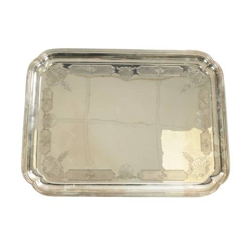 441 - A LARGE MID 20TH CENTURY SILVER RECTANGULAR TRAY with clipped corners and shell engraved border rais... 