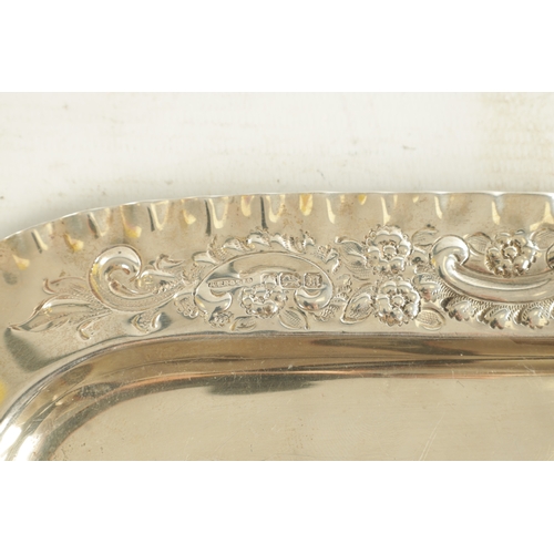 442 - AN EDWARD VII SILVER RECTANGULAR TRAY with florally embossed scroll work crimped border and plain ce... 