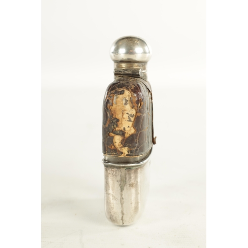 458 - A SMALL EARLY 20TH CENTURY SILVER MOUNTED CROCODILE SKIN HIP FLASK the glass body with hinged bayone... 