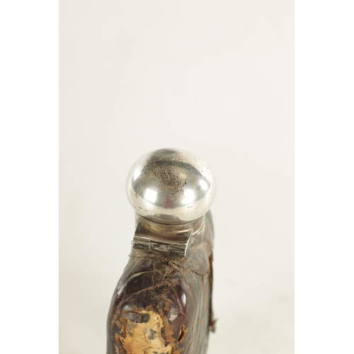 458 - A SMALL EARLY 20TH CENTURY SILVER MOUNTED CROCODILE SKIN HIP FLASK the glass body with hinged bayone... 