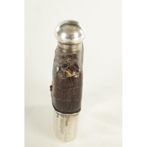 458 - A SMALL EARLY 20TH CENTURY SILVER MOUNTED CROCODILE SKIN HIP FLASK the glass body with hinged bayone... 