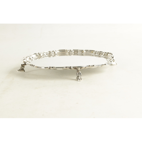 469 - A MAPPIN & WEBB SILVER PLATE SALVER with scalloped pie-crust border and four splay feet supports. (2... 