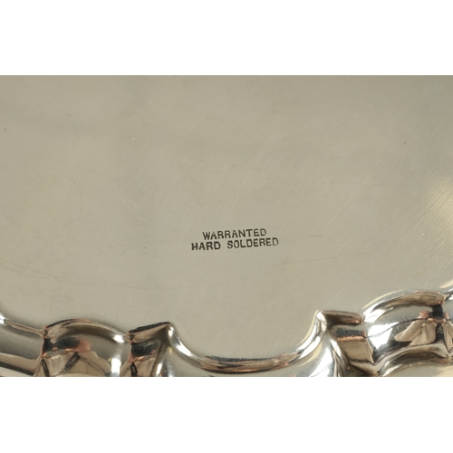 469 - A MAPPIN & WEBB SILVER PLATE SALVER with scalloped pie-crust border and four splay feet supports. (2... 