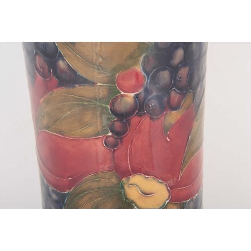 47 - AN EARLY WILLIAM MOORCROFT FLARED TALL SLENDER VASE WITH SWOLLEN FOOT decorated all around in the po... 