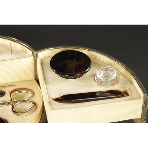 471 - LARGE OVAL SILVER MOUNTED TORTOISESHELL MANICURE SET, of oval form with hinged lid and front opening... 