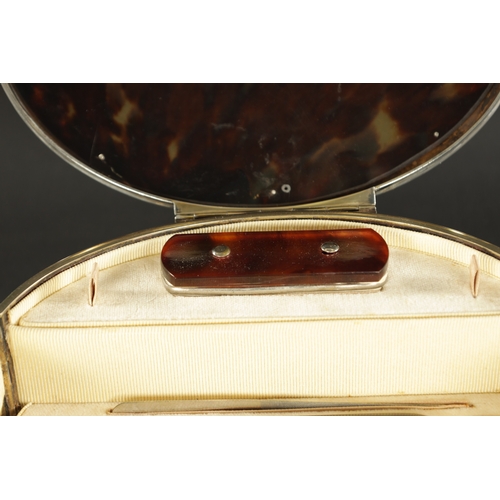 471 - LARGE OVAL SILVER MOUNTED TORTOISESHELL MANICURE SET, of oval form with hinged lid and front opening... 