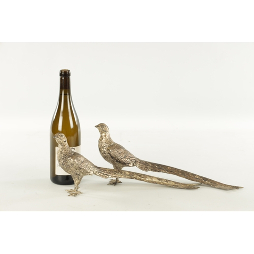 472 - A PAIR OF SILVER-PLATED PHEASANTS - stamped and numbered 2216 Copyright U.S. (38cm wide 16cm high)