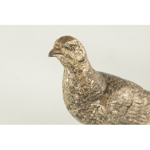 472 - A PAIR OF SILVER-PLATED PHEASANTS - stamped and numbered 2216 Copyright U.S. (38cm wide 16cm high)