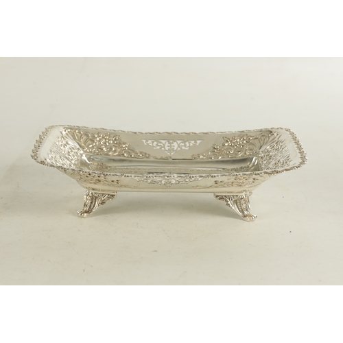 473 - AN EDWARD VII SILVER FRUIT DISH of rectangular form with embossed scrolling fruit and leafwork panel... 