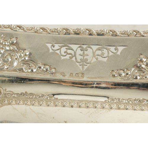 473 - AN EDWARD VII SILVER FRUIT DISH of rectangular form with embossed scrolling fruit and leafwork panel... 