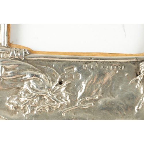 475 - AN UNUSUAL ART NOUVEAU PERIOD SILVER PICTURE FRAME, having repousse decoration depicting the Native ... 